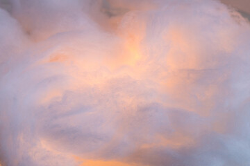 Abstract image made using colored light and cotton snow, artificial snow. Dramatic concept of clouds in the sky, storm at sea, light and dark, atmospheric states. Background or wallpaper.