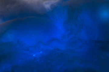 Abstract image made using colored light and cotton snow, artificial snow. Dramatic concept of...