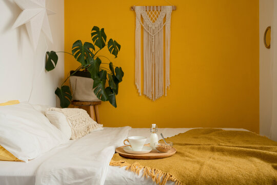 Interior of cozy bedroom with served coffee