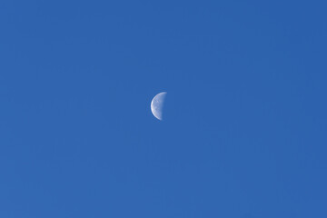 Beautiful crescent moon seen from Axalp, Canton Bern, on a sunny autumn morning. Photo taken October 18th, 2022, Axalp, Switzerland.