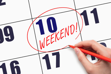 10th day of the month. Hand writing text WEEKEND and circling the calendar date. Business. Day of the year concept.