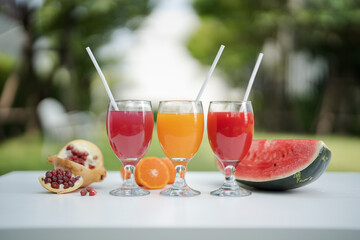 Orange juice, pomegranate juice and watermelon juice on the natural background