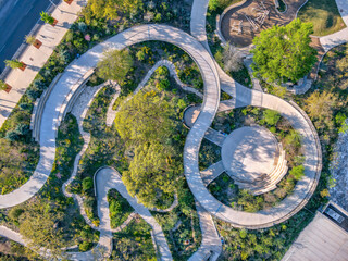 Obraz na płótnie Canvas Aerial view of a park with small amphitheater and spiral pathway near the highway at Austin, Texas