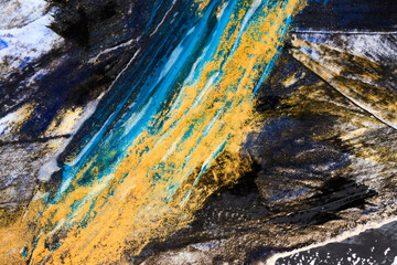 Alcohol ink abstract luxury background. Gold blue black contrasting brushstrokes blots and stains...