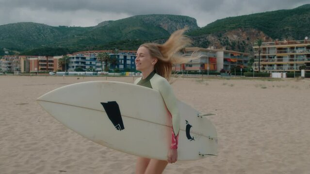 Professional athlete surfer woman run with surfboard. Surfing lifestyle. Gimbal shot of woman with surf board run on beach