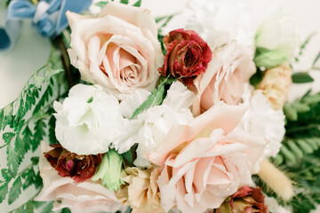 Elegant wedding bouquet with white, pink, and red roses with pops of greenery