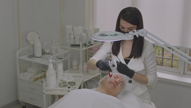 Close-up of a woman face. Needle mesotherapy procedure into the skin of the face