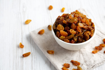 Organic Dried Raisins in a White Bowl, low angle view.