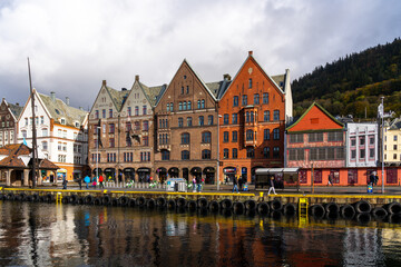 Fototapeta na wymiar Bergen, Norway - October 10, 2022: Colorful Bryggen Hanseatic Wharf (Tyskebryggen) in Bergen, Norway. Bryggen Hanseatic Wharf is one of Bergen's most popular tourist attractions. 