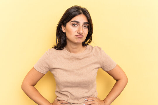 Young Indian Woman Isolated On Yellow Background Sad, Serious Face, Feeling Miserable And Displeased.