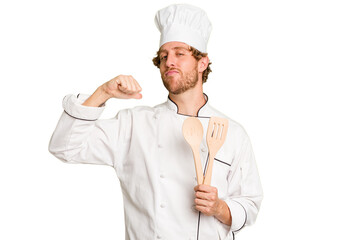 Young cook man isolated on white background feels proud and self confident, example to follow.