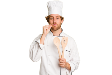 Young cook man isolated on white background with fingers on lips keeping a secret.