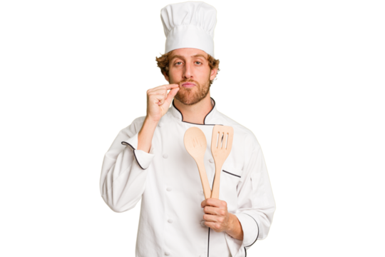 Young cook man isolated on white background with fingers on lips keeping a secret.