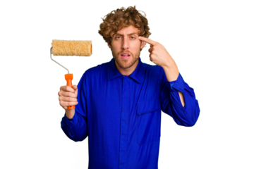 Young painter man holding a roll isolated on white background showing a disappointment gesture with forefinger.
