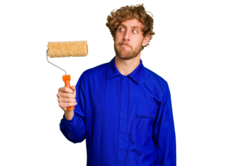 Young painter man holding a roll isolated on white background confused, feels doubtful and unsure.