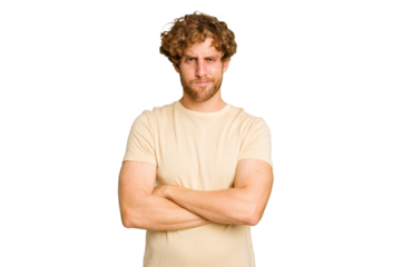 Young caucasian man isolated on green chroma background frowning face in displeasure, keeps arms folded.