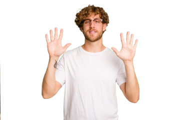 Young caucasian man isolated on green chroma background showing number ten with hands.