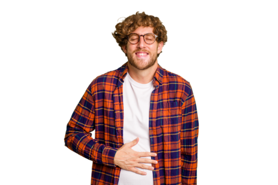 Young caucasian man isolated on green chroma background touches tummy, smiles gently, eating and satisfaction concept.