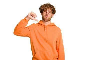Young caucasian man isolated on green chroma background showing a dislike gesture, thumbs down....