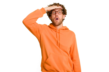 Young caucasian man isolated on green chroma background looking far away keeping hand on forehead.