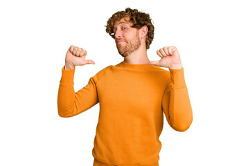 Young caucasian man isolated on green chroma background feels proud and self confident, example to...