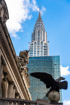 New York City, United States - September 20, 2022. The Spire Of The Chrysler Building Against The Backdrop Of An Eagle On The Facade Of The Central Station