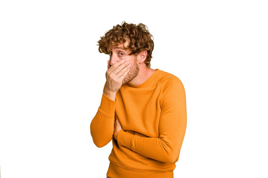 Young caucasian man isolated on green chroma background scared and afraid.