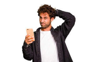 Young caucasian man using mobile phone isolated touching back of head, thinking and making a choice.