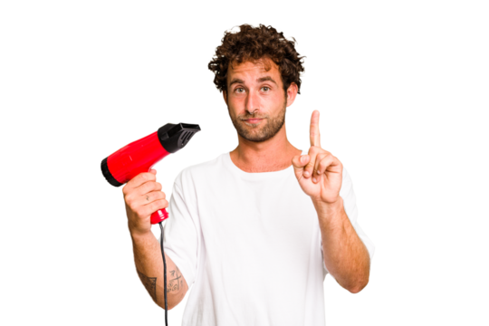Young caucasian man holding an hairdryer isolated showing number one with finger.