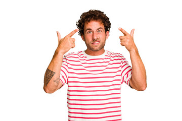 Fototapeta premium Young caucasian curly hair man isolated Young caucasian man with curly hair isolated showing a disappointment gesture with forefinger.