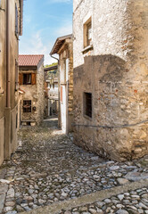 Fototapeta na wymiar Narrow cobblestones streets in ancient painted village Arcumeggia in province of Varese.