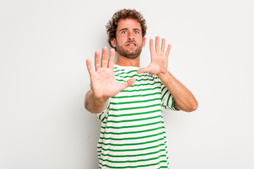 Fototapeta premium Young caucasian curly hair man isolated on white background being shocked due to an imminent danger
