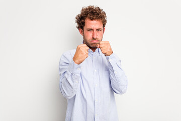 Young caucasian curly hair man isolated on white background showing fist to camera, aggressive facial expression.