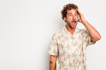 Young caucasian curly hair man isolated on white background shouts loud, keeps eyes opened and hands tense.