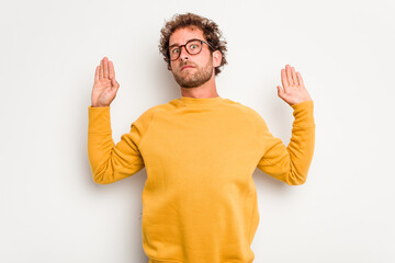 Young caucasian curly hair man isolated on white background being shocked due to an imminent danger