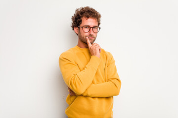 Fototapeta na wymiar Young caucasian curly hair man isolated on white background contemplating, planning a strategy, thinking about the way of a business.