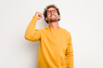 Young caucasian curly hair man isolated on white background celebrating a victory, passion and enthusiasm, happy expression.