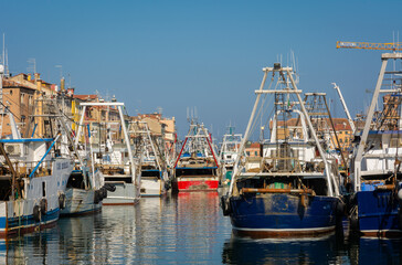 Big fishing boats moored in the port on the Adriatic sea at Chioggia city, Venetian lagoon, Venice province, northern Italy - october 30, 2021