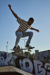 Portrait of young non-binary doing flip tricks on skateboard at skatepark © Sheilby Macena