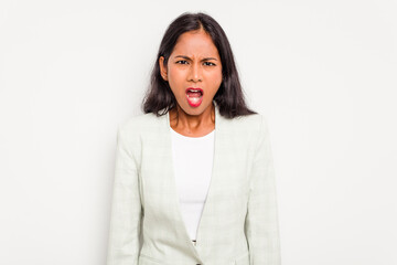 Young business Indian woman isolated on white background screaming very angry and aggressive.