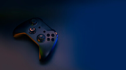 gamer playing the online game with joystick controller in neon glow dark cyberpunk room, gaming and e-sports challenge tournament streaming, streamer with analog device in living house © issaronow