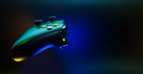 gamer playing the online game with joystick controller in neon glow dark cyberpunk room, gaming and e-sports challenge tournament streaming, streamer with analog device in living house © issaronow