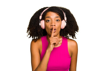 Young African American woman wearing headphones isolated keeping a secret or asking for silence.