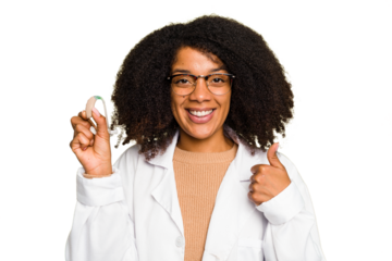 Young otorhinolaryngologist African american woman holding hearing aid isolated smiling and raising thumb up