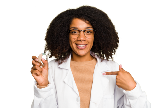Young otorhinolaryngologist African american woman holding hearing aid isolated person pointing by hand to a shirt copy space, proud and confident