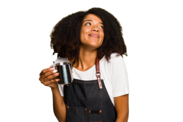 Young African American woman barista isolated dreaming of achieving goals and purposes