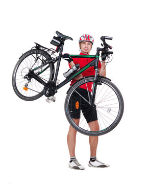 Full length front view picture of a cyclist carrying his bicycle