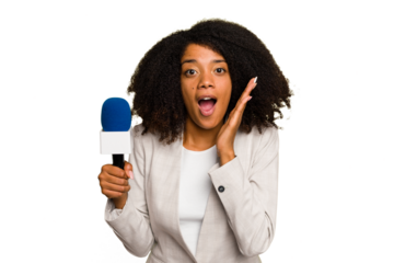 Young TV presenter African American woman with a microphone isolated surprised and shocked.