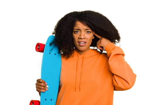 Young skater African American woman holding a little skate isolated showing a disappointment gesture with forefinger.