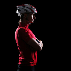 Profile low key silhouette portrait of a cyclist with crossed hands